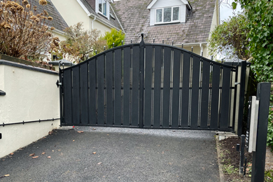 black electric gates with entry system to private residential house drive