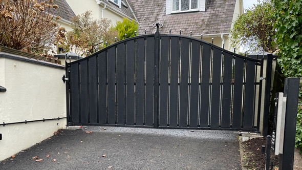 black electric entry gates to private house drive
