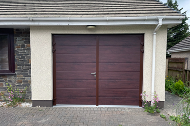 red wood sectional garage door attached to bungalow